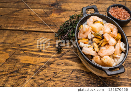 Ready for cooking fresh Raw Seafood Cocktail with Mussels, Clams, Prawns, Shrimps and squid in skillet. wooden background. top view Ready for cooking fresh Raw Seafood Cocktail with Mussels, Clams, Prawns, Shrimps and squid in skillet. wooden background. top view 122870466