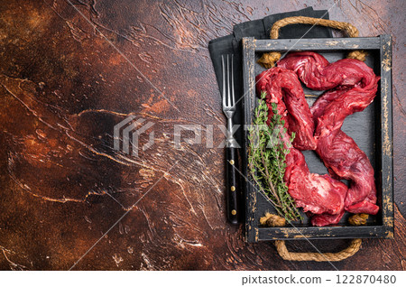 Beef cut Machete Skirt Steak, raw marble meat in wooden tray. black background. top view 122870480