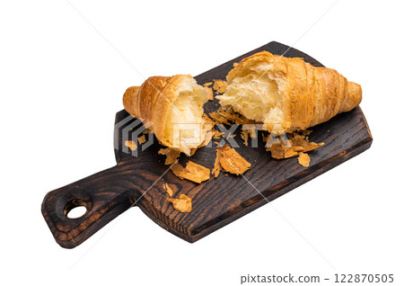 Broken fresh baked French croissant isolated on white background. Broken fresh baked French croissant isolated on white background. 122870505