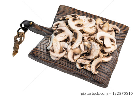 Raw Sliced champignons Mushrooms on a wooden cutting board isolated on white background. 122870510