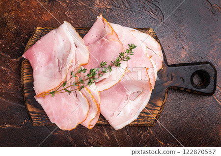 Ham Prosciutto Cotto, Sliced Pork Ham on wooden board. brown background. top view Ham Prosciutto Cotto, Sliced Pork Ham on wooden board. brown background. top view 122870537