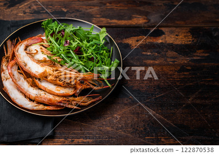 Seafood dinner with Grilled red Shrimps Prawns Langostino Austral on a plate with salad. wooden background. top view 122870538