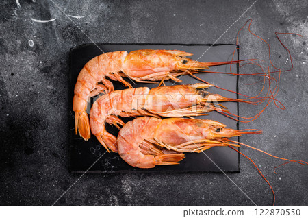 Fresh red Argentine shrimps, raw Prawns Langostino Austral. black background. top view Fresh red Argentine shrimps, raw Prawns Langostino Austral. black background. top view 122870550