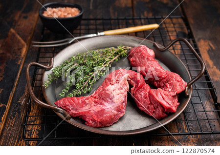 Raw Beef Machete Skirt Steak, fresh marble meat with herbs. wooden background. top view Raw Beef Machete Skirt Steak, fresh marble meat with herbs. wooden background. top view 122870574