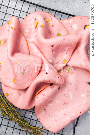 Slices Of Traditional Italian antipasti mortadella Bolognese. grey background. top view 122870709