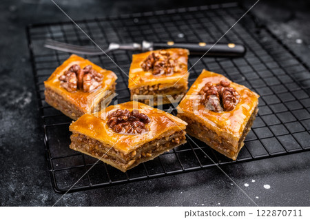 Traditional Honey Walnut Baklava. black background. top view Traditional Honey Walnut Baklava. black background. top view 122870711