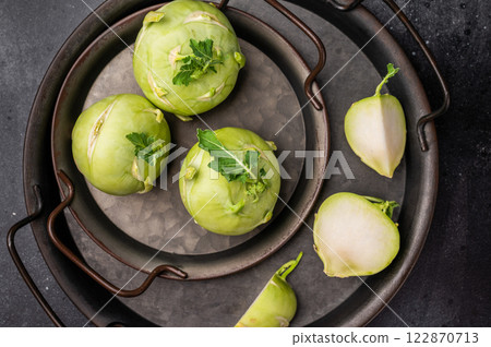 Raw kohlrabi on steel tray, Vegetable from Organic farm. black backround. top view 122870713