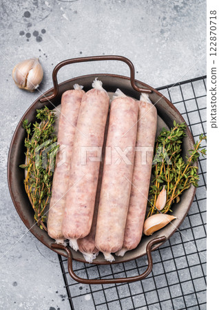 Homemade raw pork sausage, german bratwurst. grey background. top view Homemade raw pork sausage, german bratwurst. grey background. top view 122870718