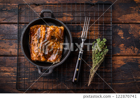 Teriyaki salmon fish fillet with glaze in a skillet. wooden background. top view Teriyaki salmon fish fillet with glaze in a skillet. wooden background. top view 122870741