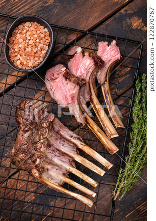 Grilled Rack of lamb, mutton meat chop steaks with thyme. wooden background. top view Grilled Rack of lamb, mutton meat chop steaks with thyme. wooden background. top view 122870767