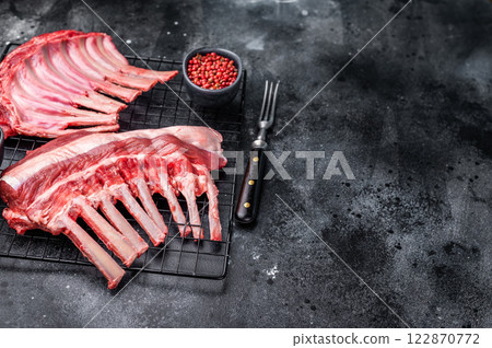 Raw rack of lamb, fresh mutton meat for chops cutlets. black background. top view 122870772