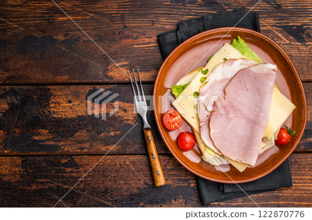 Prosciutto Cotto Ham and cheese sandwich, toast with sliced meat, cheese and salad. wooden background. top view Prosciutto Cotto Ham and cheese sandwich, toast with sliced meat, cheese and salad. wooden background. top view 122870776