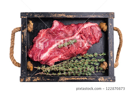 Uncooked hanging tender beef steak, Hanger steak in wooden tray with herbs isolated on white background. top view 122870873