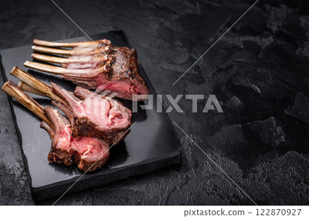Roasted lamb chops steaks, mutton meat cutlets. black background. top view Roasted lamb chops steaks, mutton meat cutlets. black background. top view 122870927