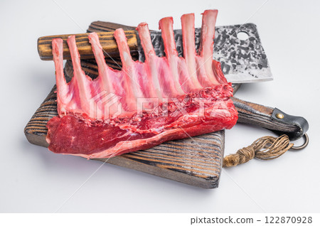 Butcher board with Raw lamb meat for chops steaks, fresh rack of mutton isolated on white background. top view Butcher board with Raw lamb meat for chops steaks, fresh rack of mutton isolated on white background. top view 122870928