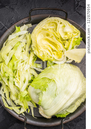 Fresh raw iceberg lettuce salad cut leaves. black background. top view 122870934