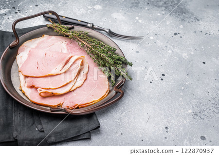 Thinly sliced pork ham, smoked meat. grey background. top view 122870937