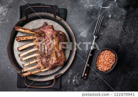 Roast Rack of lamb chops, mutton organic meat. black background. top view Roast Rack of lamb chops, mutton organic meat. black background. top view 122870941
