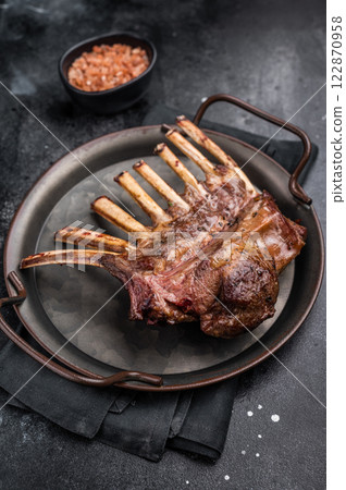 Roast Rack of lamb chops, mutton organic meat. black background. top view Roast Rack of lamb chops, mutton organic meat. black background. top view 122870958