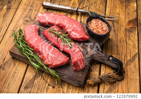 Raw marbled beef Steak, beef meat on wooden board with herbs. wooden background. top view 122870992