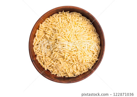 Raw Orzo pasta, uncooked dry Italian risoni in a bowl isolated on white background. top view Raw Orzo pasta, uncooked dry Italian risoni in a bowl isolated on white background. top view 122871036