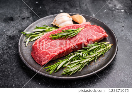 Australian Oyster Top blade steak, Fresh Beef shoulder meat on plate. black background. top view 122871075