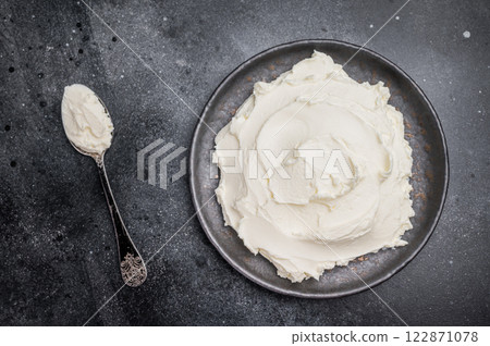Creamy Homemade Mascarpone cheese, cream cheese. black background. top view Creamy Homemade Mascarpone cheese, cream cheese. black background. top view 122871078