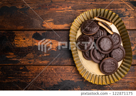 Steel plate with Jaffa Cookies covered with chocolate and filled with jam. Wooden background. top view 122871175