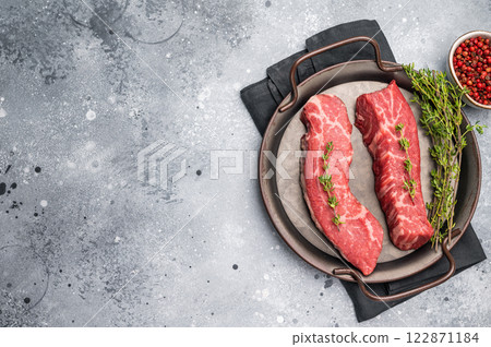 Raw Tri Tip Steak from Black Angus beef meat in stell tray. grey background. top view 122871184