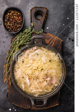 Chicken noodle soup with Vermicelli and meat in a bowl. black background. top view Chicken noodle soup with Vermicelli and meat in a bowl. black background. top view 122871197