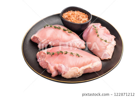 Raw Chicken thigh fillet meat, Skinless boneless poultry meat on a plate isolated on white background Raw Chicken thigh fillet meat, Skinless boneless poultry meat on a plate isolated on white background 122871212