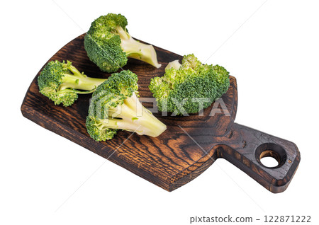 Fresh raw broccoli pieces on a wooden board isolated on white background. top view Fresh raw broccoli pieces on a wooden board isolated on white background. top view 122871222
