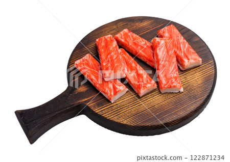 Crab sticks, crabmeat on wooden board isolated on the white background. top view Crab sticks, crabmeat on wooden board isolated on the white background. top view 122871234
