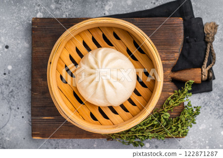 Chinese Bao or Baozi bun with meat in bamboo steamer. grey background. top view 122871287