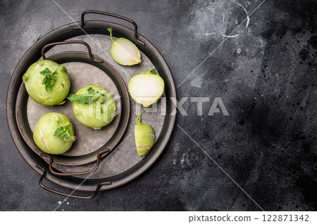Raw kohlrabi on steel tray, Vegetable from Organic farm. black backround. top view 122871342
