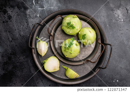 Raw kohlrabi on steel tray, Vegetable from Organic farm. black backround. top view Raw kohlrabi on steel tray, Vegetable from Organic farm. black backround. top view 122871347