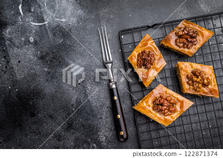 Traditional Honey Walnut Baklava. black background. top view Traditional Honey Walnut Baklava. black background. top view 122871374