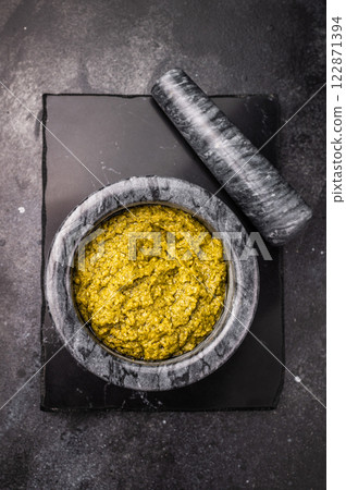 Iitalian spread sauce pesto with green basil in bowl. black background. top view 122871394