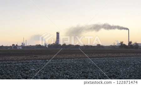 Heavy gray smoke is poured from the chimney pipes of thermal power plant. Carbon dioxide emitting from chimneys from industrial factory into the atmosphere. Concept of environmental pollution problem Heavy gray smoke is poured from the chimney pipes of thermal power plant. Carbon dioxide emitting from chimneys from industrial factory into the atmosphere. Concept of environmental pollution problem 122871474