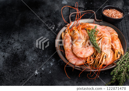 Red Argentine shrimps, raw Prawns Langostino Austral in steel tray. black background. top view Red Argentine shrimps, raw Prawns Langostino Austral in steel tray. black background. top view 122871478