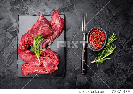 Raw Beef Machete Steak, also name Skirt steak, fresh marble meat. black background. top view 122871479