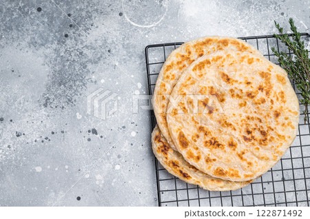 Homemade Kerala wheat paratha, layered parotta. grey background. top view Homemade Kerala wheat paratha, layered parotta. grey background. top view 122871492