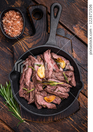 Grilled and sliced Beef top sirloin Steak in a pan. wooden background. top view 122871506