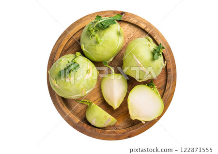 Raw kohlrabi sliced on pieces on wooden tray isolated on white backround. top view Raw kohlrabi sliced on pieces on wooden tray isolated on white backround. top view 122871555