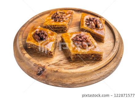 Arabic Traditional Honey Walnut Baklava on wooden board isolated on white background. top view 122871577