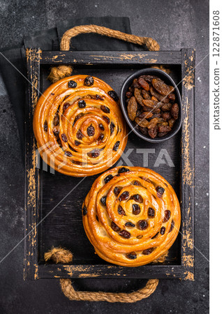Danish raisin pastry swirls. black background. top view 122871608