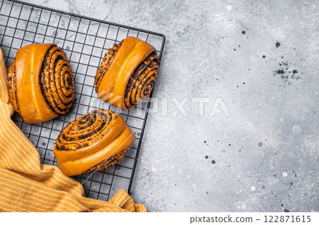 Baked Poppy Seed Rolls. grey background. top view Baked Poppy Seed Rolls. grey background. top view 122871615