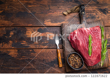 Butcher cutting board with Raw Wild Boar meat, fresh Game Meat. wooden background. top view Butcher cutting board with Raw Wild Boar meat, fresh Game Meat. wooden background. top view 122871622