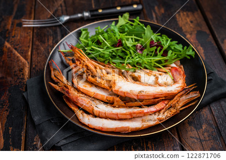 Seafood dinner with Grilled red Shrimps Prawns Langostino Austral on a plate with salad. wooden background. top view 122871706