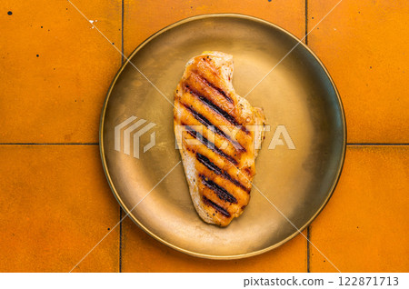Grilled Chicken breast steak on a plate, fried poultry meat, top view. 122871713